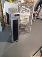 Photo showing closed wine cooler and metal wine rack in original packaging