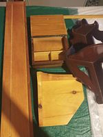 Photo showing all wood display pieces: long plate rack, corner shelves, cash/trinket box.