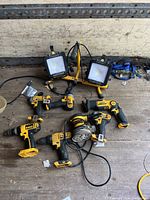 Overview showing dual-head LED work light, sander, hammer drills and drivers