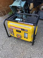 Full view of yellow Champion generator in black frame showing recoil starter and controls