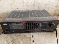 Front and top view of black metal chassis showing vented cover and front controls.