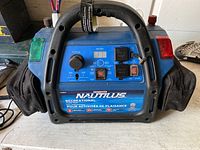 Motomaster Nautilus Recreational Power Pack Battery showing front control panel, handle, sockets, indicator lights, and side pockets.