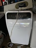 Full view of white Insignia portable air conditioner unit showing control panel and power cord.