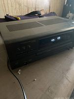 Front and top angled view of vintage stereo receiver with control panel and display masks.