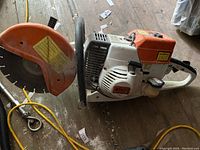 Left side view of Stihl petrol concrete saw showing housing, handle and blade guard