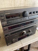 Three stacked Technics audio components: amplifier on top, equalizer in middle, receiver at bottom.