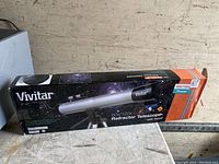 Vivitar branded telescope box with space-themed graphics, showing the full product packaging.