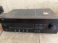 Front view of Yamaha RX-396 stereo receiver showing control panel with knobs and buttons for volume, bass, treble, balance, input selection, headphone jack, and speakers.