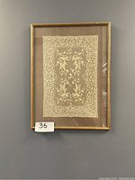 Photo of hand made Venetian lace framed in 20x24 gold-tone frame, showing detailed floral pattern lace.
