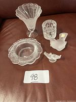 All five Lalique pieces displayed on leather surface