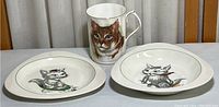 Photo showing two cat illustrated dishes and a bone china cup with a cat portrait