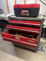 Photo of the larger red Craftsman rolling toolbox with some drawers open and a smaller carry away toolbox placed on top.