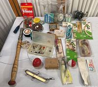 Full view of fishing collection including rod, reels, lines, lures, bobbers, hooks, and accessories.