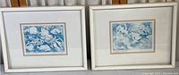 Pair of framed fish prints side-by-side showing overall appearance, white frames and matting.