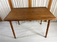 Full view of the vintage wood side table showing the tabletop, legs, and overall condition.