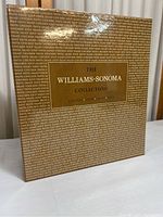 Front view of sealed Williams-Sonoma Collection box with repeating text and gold label
