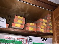 Wooden shelf holding multiple Besondere Model 4600 chisel boxes