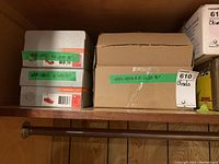 Three containers boxed with green tape labeled Wood Chisel A-2035 1/4 inch.