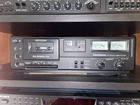 Front view of Telefunken HC1500 cassette player showing buttons, tape slot, VU meters, and control knobs.