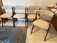 Three chairs side by side against wall showing overall set