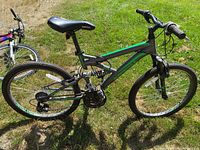 Full side view of the Supercycle mountain bike showing its frame, tires, and seat.