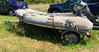 Inflatable dinghy on trailer with motor