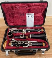 Yamaha 4C clarinet disassembled into three pieces inside open carrying case with plush red lining.