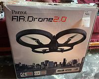 Front box view showing Parrot AR Drone 2.0 branding, drone image, and HD camera specification