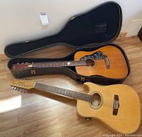 Both guitars displayed with hard shell case open