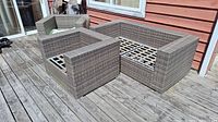 View of both loveseat and chair on a wooden patio deck showing overall condition and materials