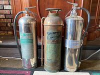 Photo showing all three vintage fire extinguishers side by side.