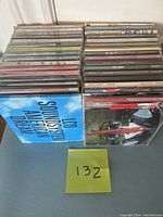 Photo showing a stacked lot of various CDs including LCD Soundsystem American Dream and others