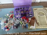 Overview of lot showing multiple beading supplies, organizers, threads, findings, beads, and a beading frame.