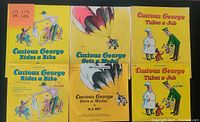 Front covers of the three Curious George books showing titles and cover illustrations.