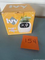 Sealed box of Ivy Smart Planter showing front packaging with product image and logo