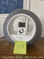 Front view of the JBL circular speaker dock with the iPod Classic docked and displaying the screen.