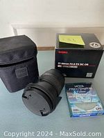 Front and side view of Sigma 17-50mm F2.8 EX DC OS HSM lens with petal lens hood, Hoya Pro1 UV filter, protective case, and original box.