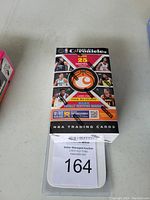 Photo of sealed 2020-21 Chronicles Basketball trading card box showing front of box with player images and promotional information.