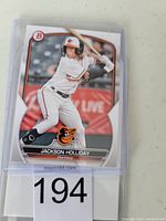 Front view of 2023 Bowman Draft baseball card featuring Jackson Holliday in Orioles uniform, showing player name and position.
