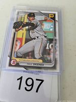 Front view of 2024 Bowman Prospects Paul Skenes baseball card in protective case with player mid-pitch photo.