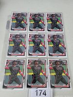 Nine 2024 Bowman baseball cards featuring rookie Elly De La Cruz, displayed face up in three rows of three, showing the player in black Cincinnati Reds uniform swinging a bat.