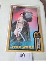 Front cover of Star Wars #22 Marvel comic book featuring Rey and Kylo Ren silhouette with 50th Lucasfilm anniversary label.