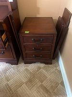 Front angle view of the wood style file cabinet showing three drawers and dark finish.