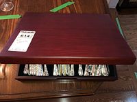 Closed dark wood flatware box showing polished wood surface and MaxSold label.