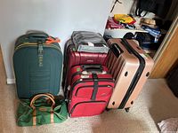 Photo of the full set of luggage grouped together including duffel bag and suitcases in various colors and sizes