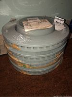 Stack of four new Chrysler brake rotors wrapped in plastic, showing partial original packaging and labels.