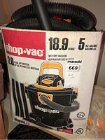 Shop Vac box showing 18.9 liters (5 gallons) capacity, wet/dry vacuum designation, and 2.0 peak HP motor.