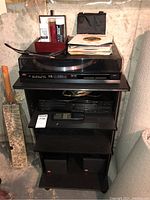 Full view of stereo stand with turntable, CD player, remote and speakers