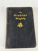 Front cover showing black textured leather with gold embossed title and a palace silhouette graphic.