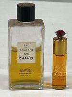 Photo showing both partial perfume bottles together with labels visible.